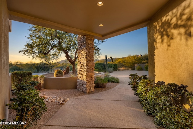 view of patio terrace at dusk