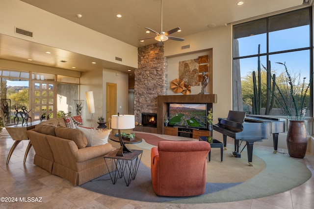 living room featuring a fireplace and a high ceiling