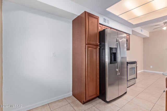 kitchen featuring stainless steel appliances, ceiling fan, and light tile patterned flooring