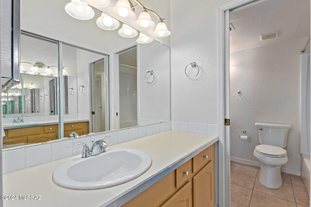 bathroom featuring vanity, toilet, and tile patterned floors