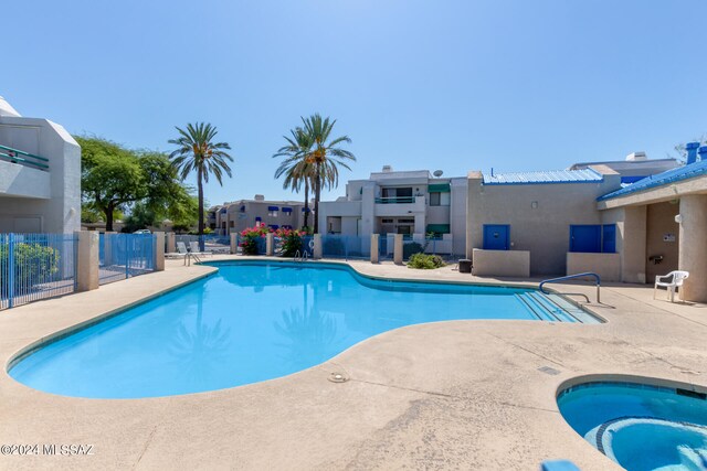 view of pool with a community hot tub and a patio area