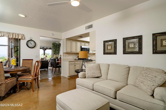 living room with wood-type flooring and ceiling fan