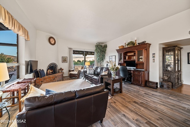 living room featuring hardwood / wood-style flooring and a fireplace