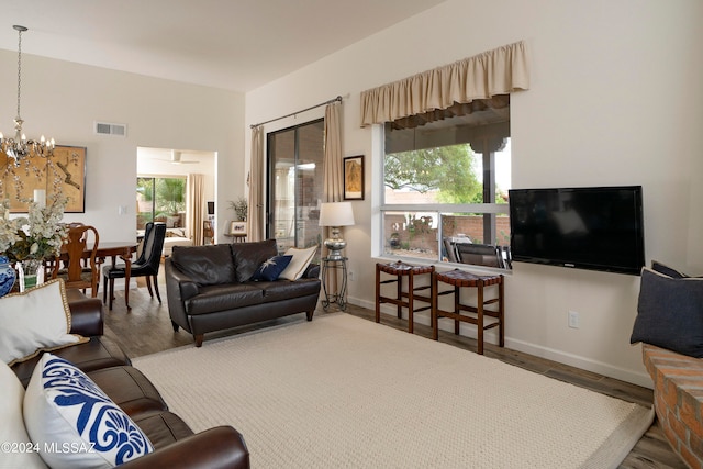 living room featuring a chandelier and hardwood / wood-style floors