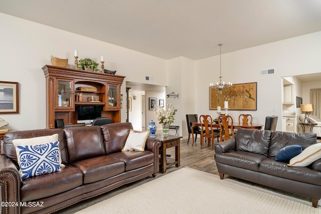 living room featuring a notable chandelier and hardwood / wood-style flooring