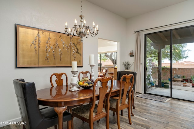 dining area featuring hardwood / wood-style floors and a chandelier