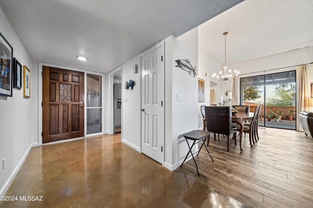 foyer featuring concrete floors and an inviting chandelier