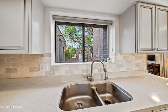 kitchen featuring tasteful backsplash and sink