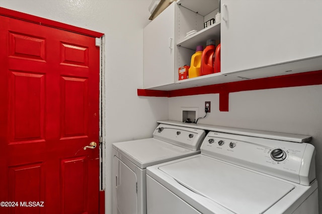 washroom featuring cabinets and washing machine and dryer