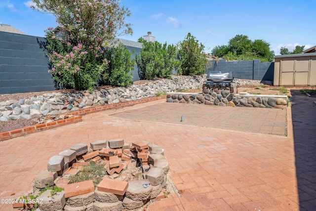 view of patio / terrace with a storage shed