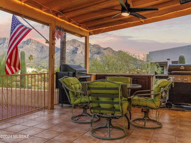 exterior space featuring area for grilling, a mountain view, and ceiling fan