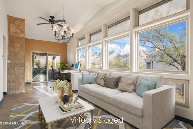 sunroom featuring lofted ceiling and ceiling fan with notable chandelier