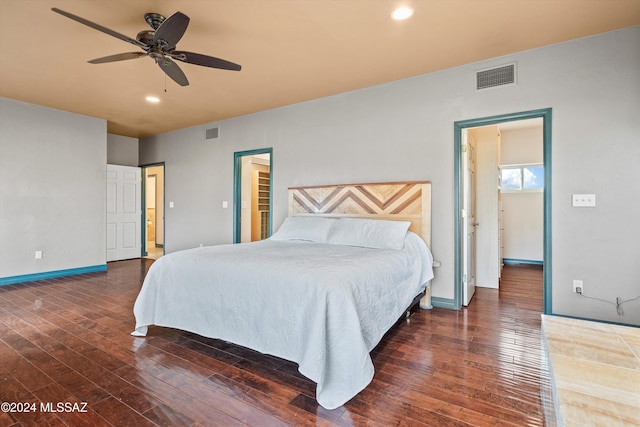 bedroom with connected bathroom, dark wood-type flooring, and ceiling fan