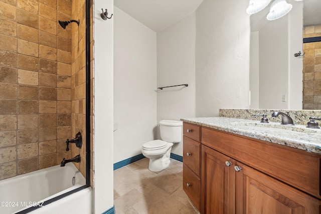 full bathroom featuring tiled shower / bath, vanity, and toilet