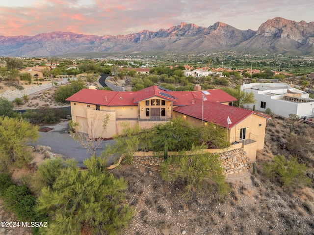 aerial view at dusk featuring a mountain view