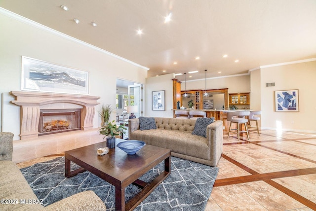 living room featuring crown molding and a tile fireplace