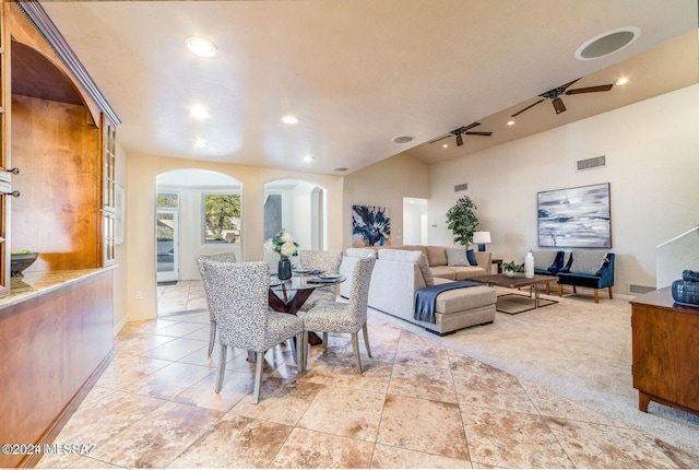 carpeted dining space with ceiling fan