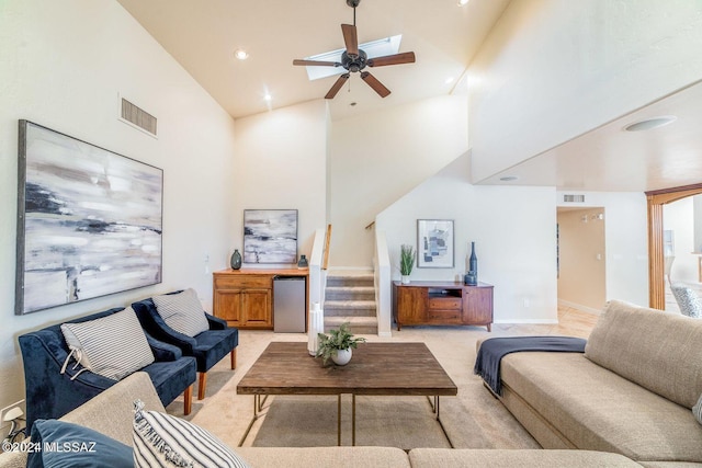 living room with high vaulted ceiling and ceiling fan