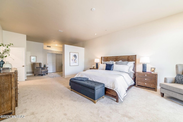 bedroom featuring light carpet and a closet