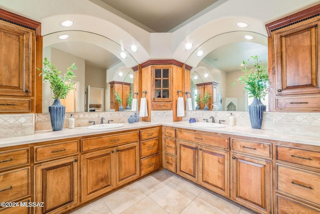 bathroom with tile patterned floors, decorative backsplash, and vanity