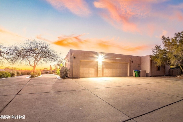 view of garage at dusk