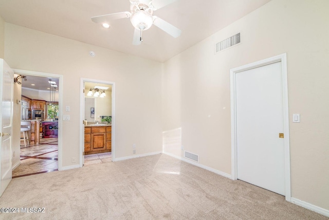 carpeted empty room with ceiling fan