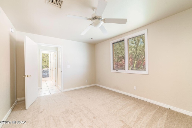 unfurnished room with ceiling fan and light colored carpet