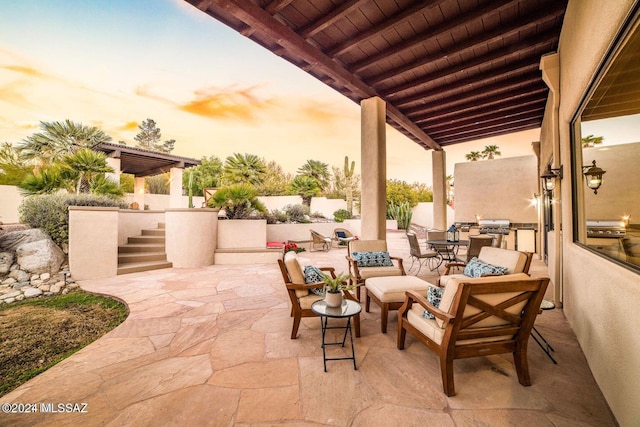 patio terrace at dusk featuring an outdoor living space