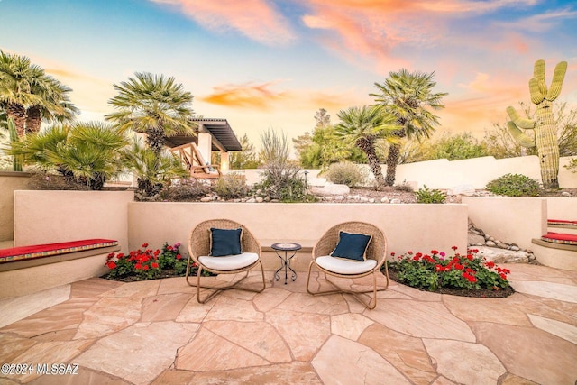 view of patio terrace at dusk