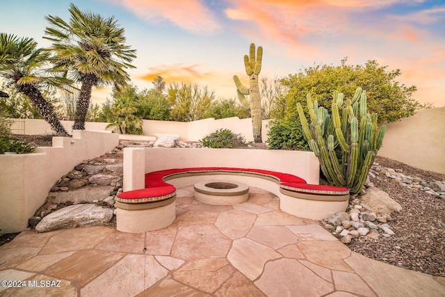 view of patio terrace at dusk