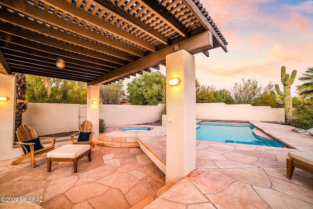 pool at dusk featuring an in ground hot tub, a pergola, and a patio