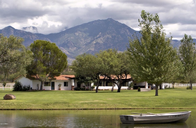 exterior space featuring a yard and a water and mountain view