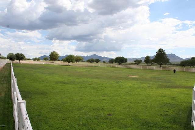 view of yard with a mountain view and a rural view
