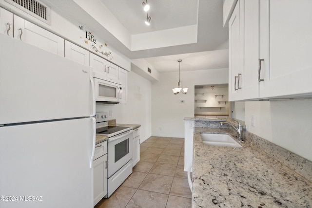 kitchen with white cabinetry, white appliances, sink, and light stone counters