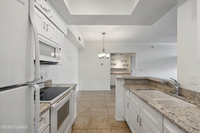 kitchen with hanging light fixtures, white appliances, sink, and white cabinets