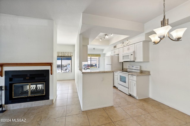 kitchen featuring light tile patterned floors, an inviting chandelier, white appliances, white cabinets, and pendant lighting