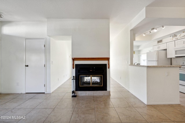 unfurnished living room with light tile patterned flooring