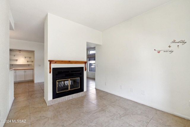 unfurnished living room with light tile patterned floors