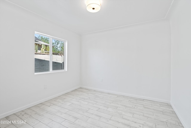 unfurnished room with light wood-type flooring