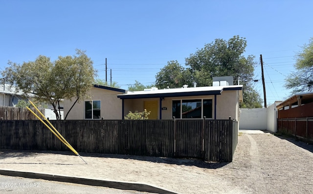 view of front of property featuring a fenced front yard and stucco siding
