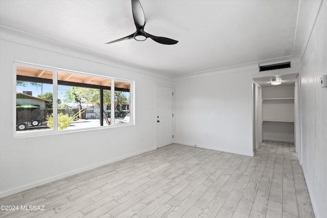 unfurnished room featuring ceiling fan and light wood-type flooring