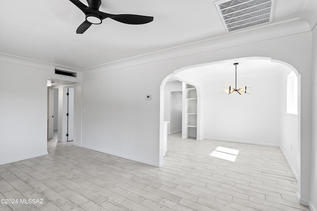 empty room featuring crown molding, light hardwood / wood-style floors, and ceiling fan with notable chandelier