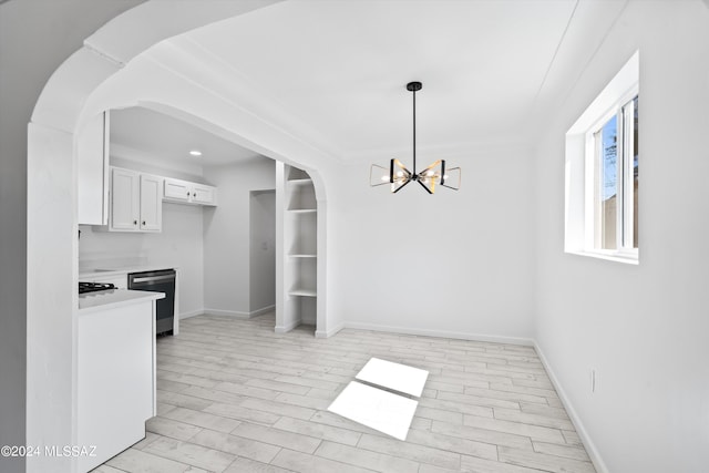 kitchen featuring white cabinets, decorative light fixtures, light hardwood / wood-style flooring, stainless steel dishwasher, and a notable chandelier