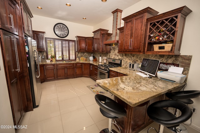 kitchen featuring a kitchen bar, kitchen peninsula, wall chimney exhaust hood, stainless steel appliances, and sink