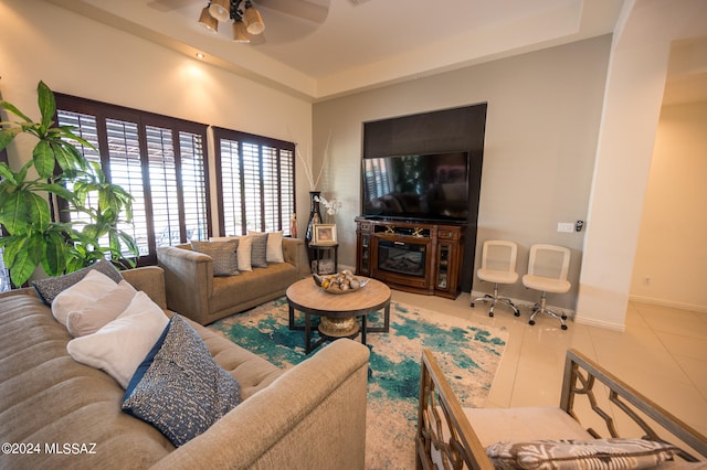 tiled living room with ceiling fan