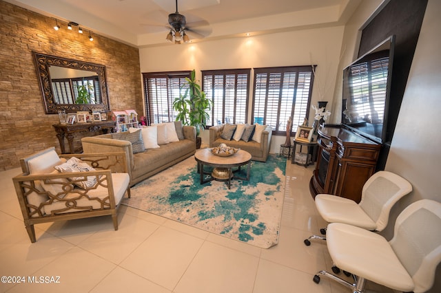 living room featuring light tile patterned floors and ceiling fan