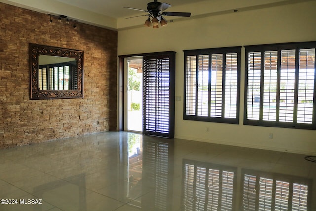 unfurnished room featuring tile patterned flooring and ceiling fan