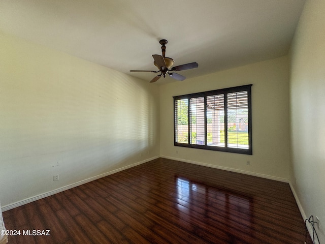 spare room featuring dark hardwood / wood-style floors and ceiling fan