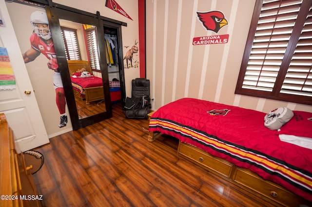 bedroom featuring wood-type flooring and a closet