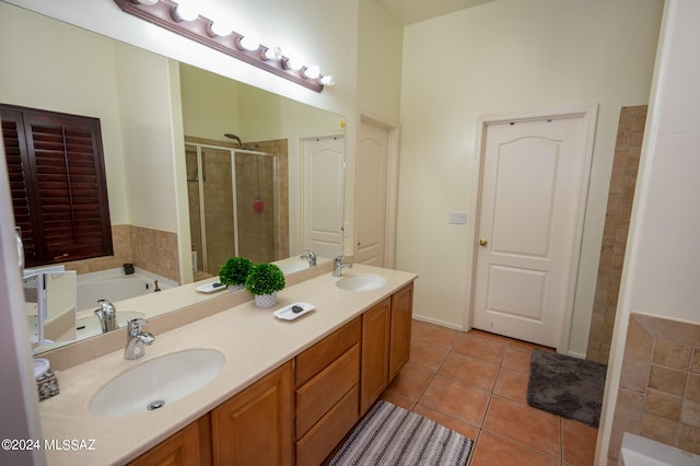 bathroom featuring tile patterned flooring, vanity, and shower with separate bathtub